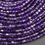 May include: A close-up image of a strand of purple amethyst gemstone beads. The beads are square shaped and have a faceted finish. The beads are arranged in a row, with the edges of the beads overlapping slightly. The beads are a deep purple color, with some lighter purple and white inclusions visible.