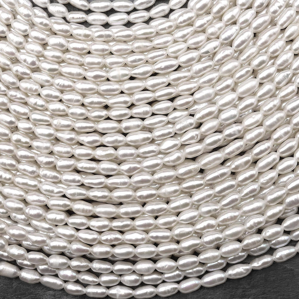 Iridescent AAA Genuine Freshwater Small Long Rice Seed Pearls White Oval Pearl 4x6mm 14" Strand