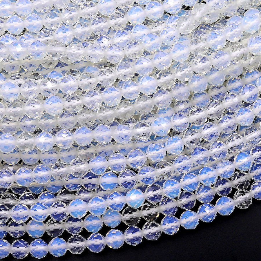 May include: A close-up of a strand of iridescent white faceted beads. The beads are round and have a smooth, polished finish. The beads are arranged in a circular pattern, creating a beautiful and intricate design.