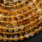 May include: A close-up of a strand of faceted citrine beads. The beads are a warm, golden yellow color and have a smooth, polished finish.